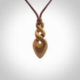 Hand carved woolly mammoth tusk double twist pendant. Made by NZ Pacific.